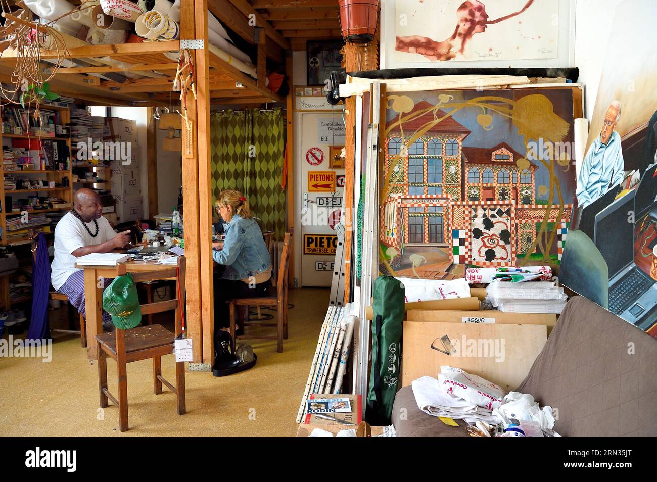 France, Paris, Barthelemy Toguo, the artist founder of Bandjoun Station in Cameroon (shown in the painting right), in his Parisian studio Stock Photo