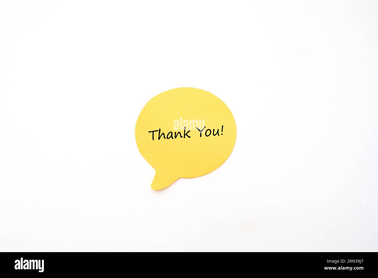 Yellow Post it Note Speech Bubble with Hand Written Thank You Text Stock Photo
