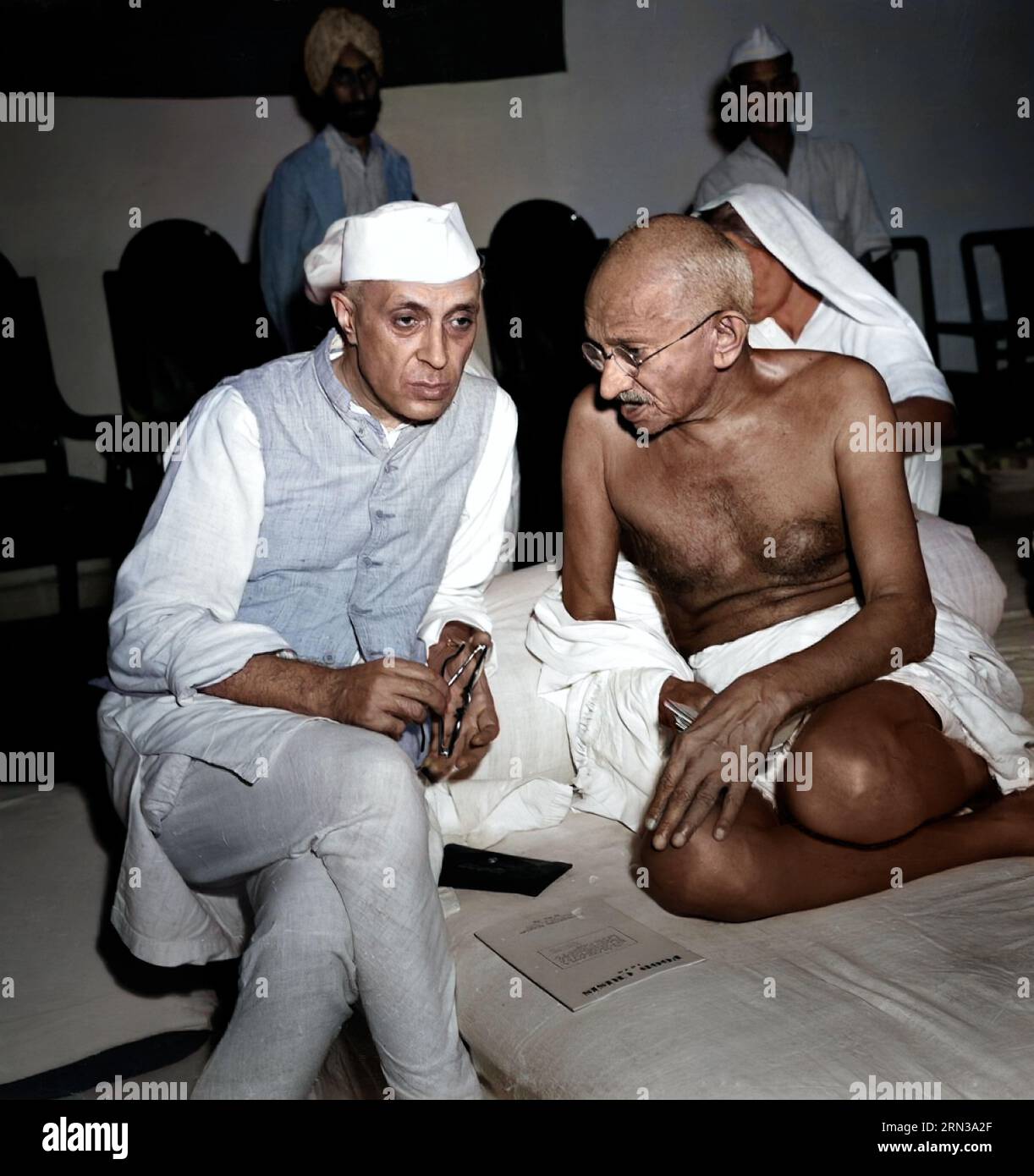 Mahatma Gandhi with Jawaharlal Nehru, three-quarter length portraits, seated, at a meeting of the All India Congress, Bombay, India. 6 July #1946.  Ph Stock Photo