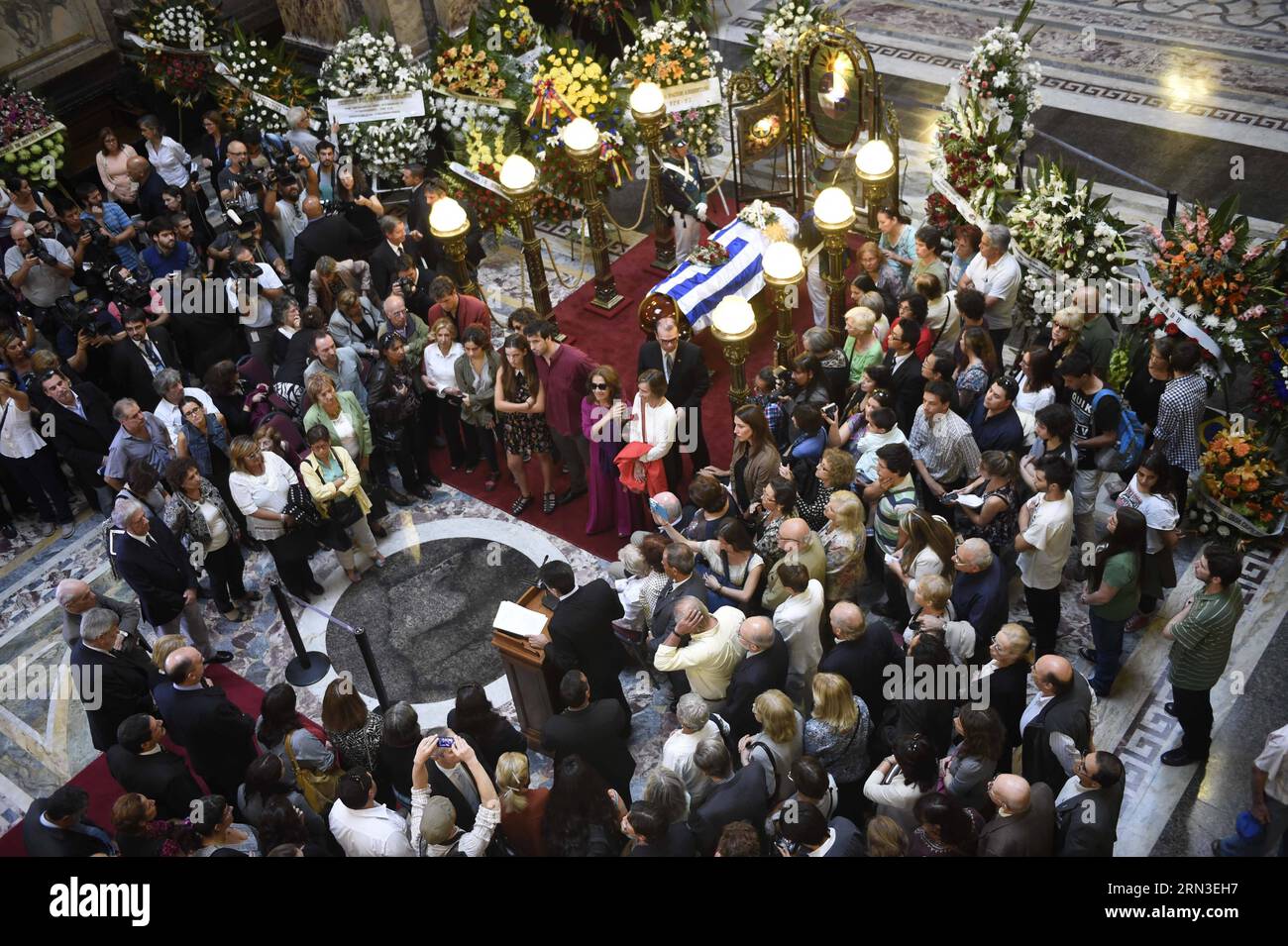 MONTEVIDEO, April 14, 2015 -- People gather around the coffin of Uruguayan writer Eduardo Galeano, during the tribute organized by the government of Uruguay, in the Hall of Lost Steps of the Legislative Palace, in Montevideo, capital of Uruguay, on April 14, 2015. According to local press, Eduardo Galeano, author of The Open Veins of Latin America (1971), died on Monday in Montevideo at the age of 74 years as a result of lung cancer. Galeano s body will be cremated on Wednesday. Nicolas Celaya) (bxq) URUGUAY-MONTEVIDEO-CULTURE-EDUARDO GALEANO e NICOLASxCELAYA PUBLICATIONxNOTxINxCHN   Montevide Stock Photo