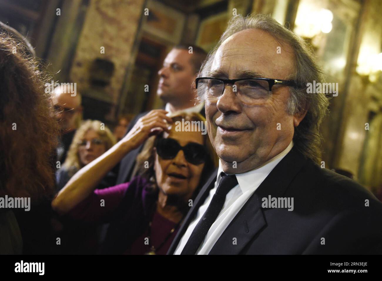 MONTEVIDEO, April 14, 2015 -- The widow of Uruguayan writer Eduardo Galeano, Helena Villagra (L) and the Spanish singer Joan Manuel Serrat, react during the tribute to Eduardo Galeano organized by the government of Uruguay, in the Hall of Lost Steps of the Legislative Palace, in Montevideo, capital of Uruguay, on April 14, 2015. According to local press, Eduardo Galeano, author of The Open Veins of Latin America (1971), died on Monday in Montevideo at the age of 74 years as a result of lung cancer. Galeano s body will be cremated on Wednesday. Nicolas Celaya) (bxq) URUGUAY-MONTEVIDEO-CULTURE-E Stock Photo