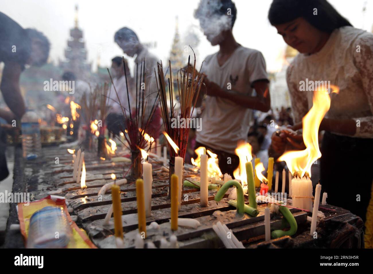 (150417) -- YANGON, April 17, 2015 -- People light candles and burn incense sticks to pray on the first day of Myanmar s new year at the world-famous Shwedagon Pagoda in Yangon, Myanmar, April 17, 2015. On the first day of Myanmar s new year, people in the country used to perform meritorious deeds and Buddhists, who account for the majority of the people, usually go to the pagodas, monasteries and meditation centers where they practice meditation. ) MYANMAR-YANGON-NEW YEAR UxAung PUBLICATIONxNOTxINxCHN   Yangon April 17 2015 Celebrities Light Candles and Burn incense Sticks to Pray ON The Firs Stock Photo