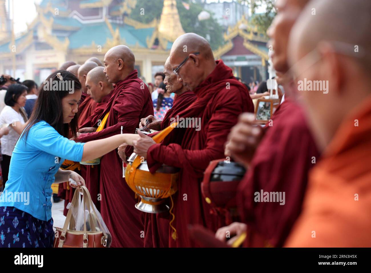 (150417) -- YANGON, April 17, 2015 -- A woman donates cash to buddhist monks on the first day of Myanmar s new year at the world-famous Shwedagon Pagoda in Yangon, Myanmar, April 17, 2015. On the first day of Myanmar s new year, people in the country used to perform meritorious deeds and Buddhists, who account for the majority of the people, usually go to the pagodas, monasteries and meditation centers where they practice meditation. ) MYANMAR-YANGON-NEW YEAR UxAung PUBLICATIONxNOTxINxCHN   Yangon April 17 2015 a Woman donate Cash to Buddhist Monks ON The First Day of Myanmar S New Year AT The Stock Photo