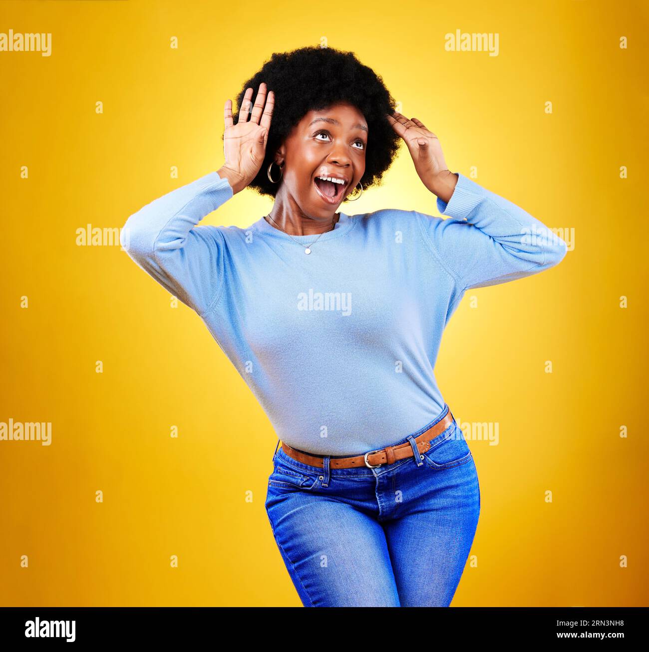 Happy black woman, wow and excited winner in celebration isolated on a yellow background in studio. Smile, surprise and shocked African person in Stock Photo