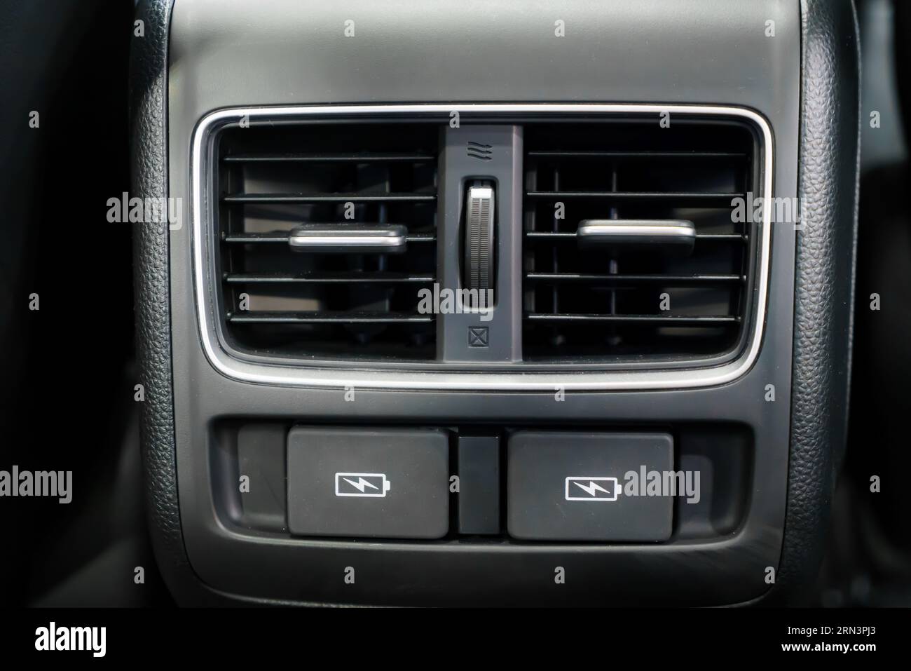 Zoom in on car panel's USB port, a tech oasis amidst leather and chrome. Power and connectivity elegantly fuse, inviting endless journeys. Stock Photo