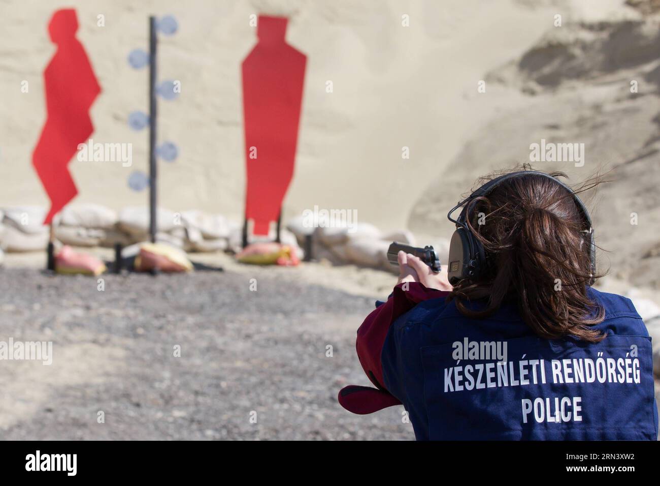 (150429) -- BUDAPEST, April 29, 2015 -- A Hungarian policewoman emulates the match during a press conference of the First World Police Service Pistol Shooting Championship in Budapest, Hungary on April 29, 2015. The Hungarian Law Enforcement Training Center announced that the First World Police Service Pistol Shooting Championship would take place in Budapest from May 4 to 6. This championship is designed to offer professional police officers the chance to compete in events that are much the same as those they regularly face.) (SP)HUNGARY--BUDAPEST-POLICE-SERVICE PISTOL-SHOOTING-WORLD CHAMPION Stock Photo