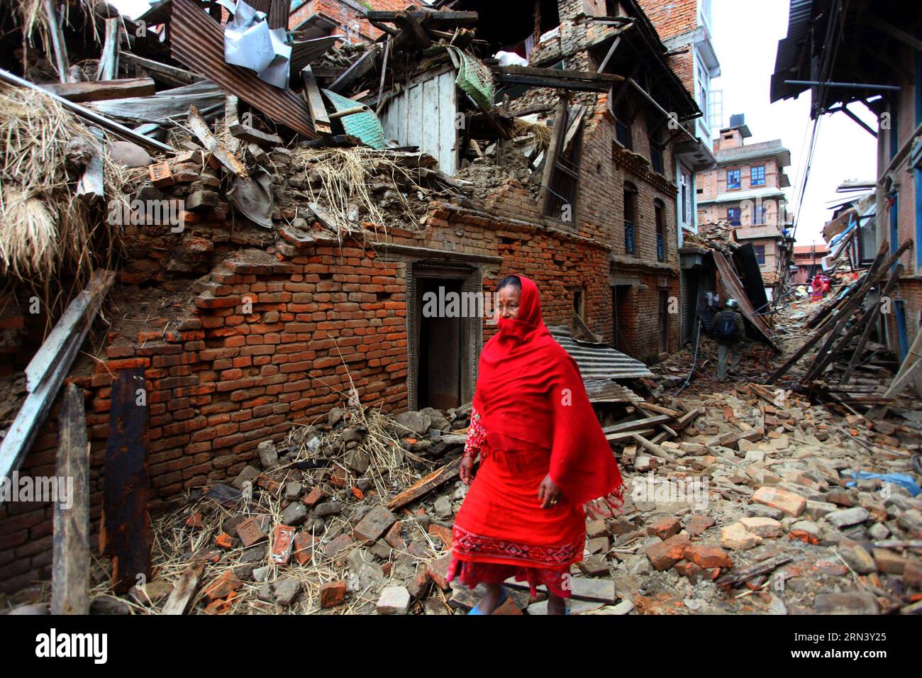 (150429) -- LALITPUR, April 29, 2015 -- A woman walks past the debris after earthquake in Lalitpur, Nepal, April 29, 2015. The 7.9-magnitude quake hit Nepal at midday on Saturday. The death toll from the powerful earthquake has soared to 5,057 and a total of 10,915 others were injured. ) (djj) NEPAL-LALITPUR-EARTHQUAKE-AFTERMATH SunilxSharma PUBLICATIONxNOTxINxCHN   Lalitpur April 29 2015 a Woman Walks Past The debris After Earthquake in Lalitpur Nepal April 29 2015 The 7 9 magnitude Quake Hit Nepal AT midday ON Saturday The Death toll from The Powerful Earthquake has soared to 5  and a total Stock Photo