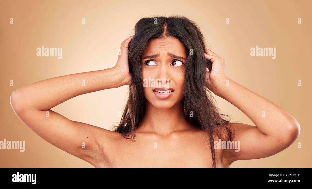 Hair loss, stress and woman with crisis, disaster and hairdresser fail in studio on brown background. Natural, frustration and shocked person, messy Stock Photo