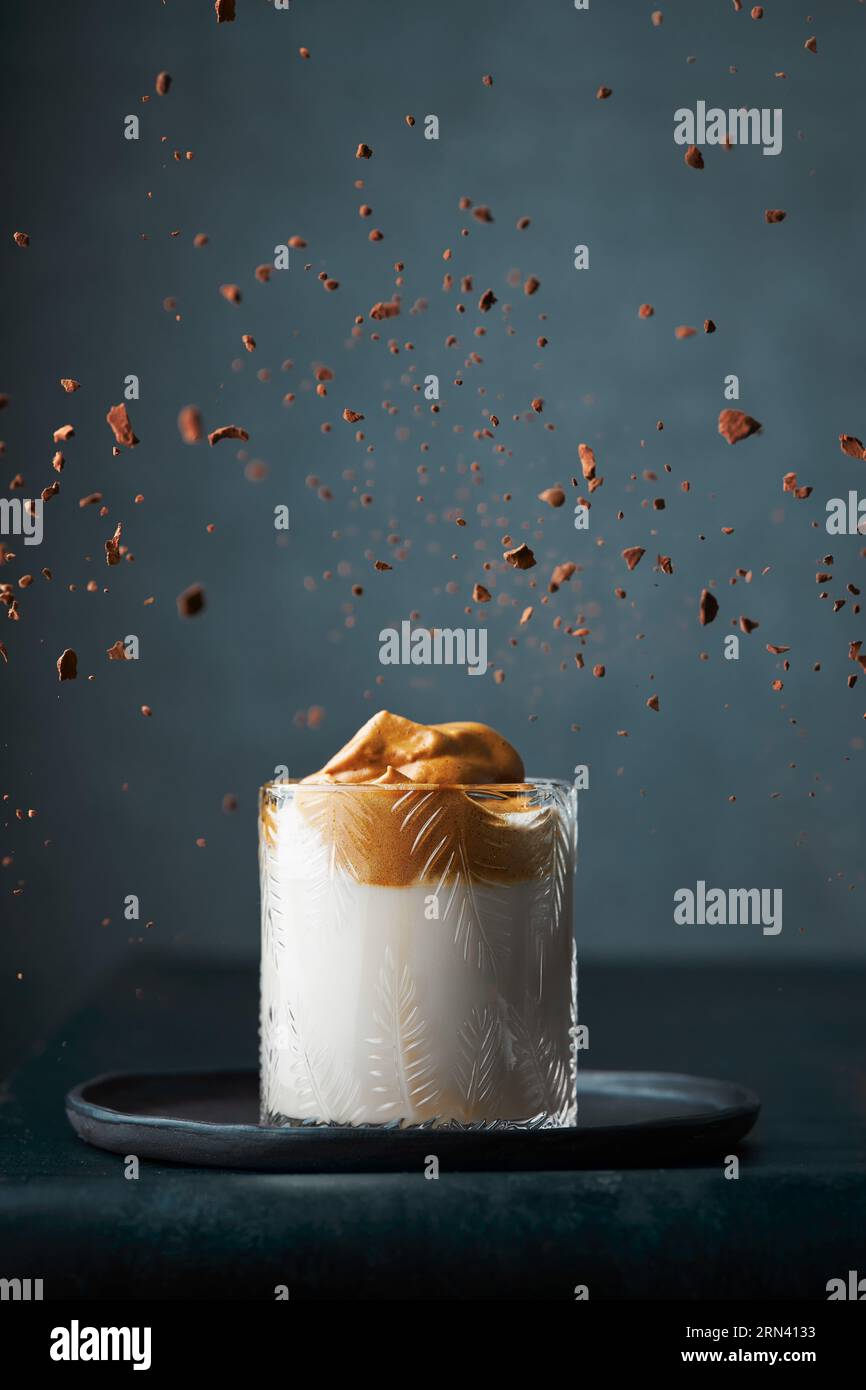 Exploding Instapot Dalgona coffee in a textured modern glass on a dark grey background ...
