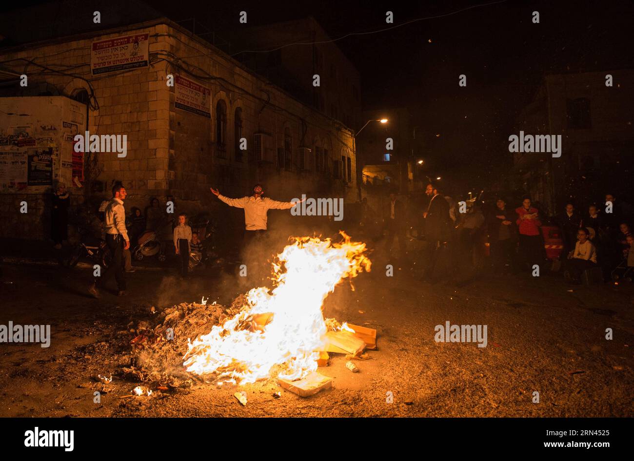 (150507) -- JERUSALEM, May 7, 2015 -- Ultra-Orthodox Jewish people celebrate Lag BaOmer around a bonfire at Mea Shearim in Jerusalem, on May 6, 2015. Lag BaOmer, also known as Lag B Omer, is a Jewish festival celebrated on the 33rd day of the Counting of the Omer, which occurs on the 18th day of the Hebrew month of Iyar. This day marks the hillula (celebration, interpreted by some as anniversary of death) of Rabbi Shimon bar Yochai, a Mishnaic sage and leading disciple of Rabbi Akiva in the 2nd century, and the day on which he revealed the deepest secrets of kabbalah in the form of the Zohar ( Stock Photo