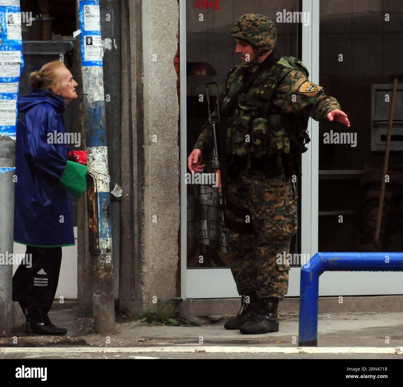 (150509) -- KUMANOVO, May 9, 2015 -- A Macedonian policeman stops a lady at a checkpoint in the town of Kumanovo in Macedon, May 9, 2015. Five Macedonian policemen were killed and more than 30 others injured in a major operation against armed group, Macedonian Interior Minister Gordana Jankuloska said Saturday evening. ) MACEDONIA-KUMANOVO-POLICE-OPERATION MIA PUBLICATIONxNOTxINxCHN   150509 Kumanovo May 9 2015 a Macedonian Policeman Stops a Lady AT a Checkpoint in The Town of Kumanovo in Macedon May 9 2015 Five Macedonian Policemen Were KILLED and More than 30 Others Injured in a Major Operat Stock Photo