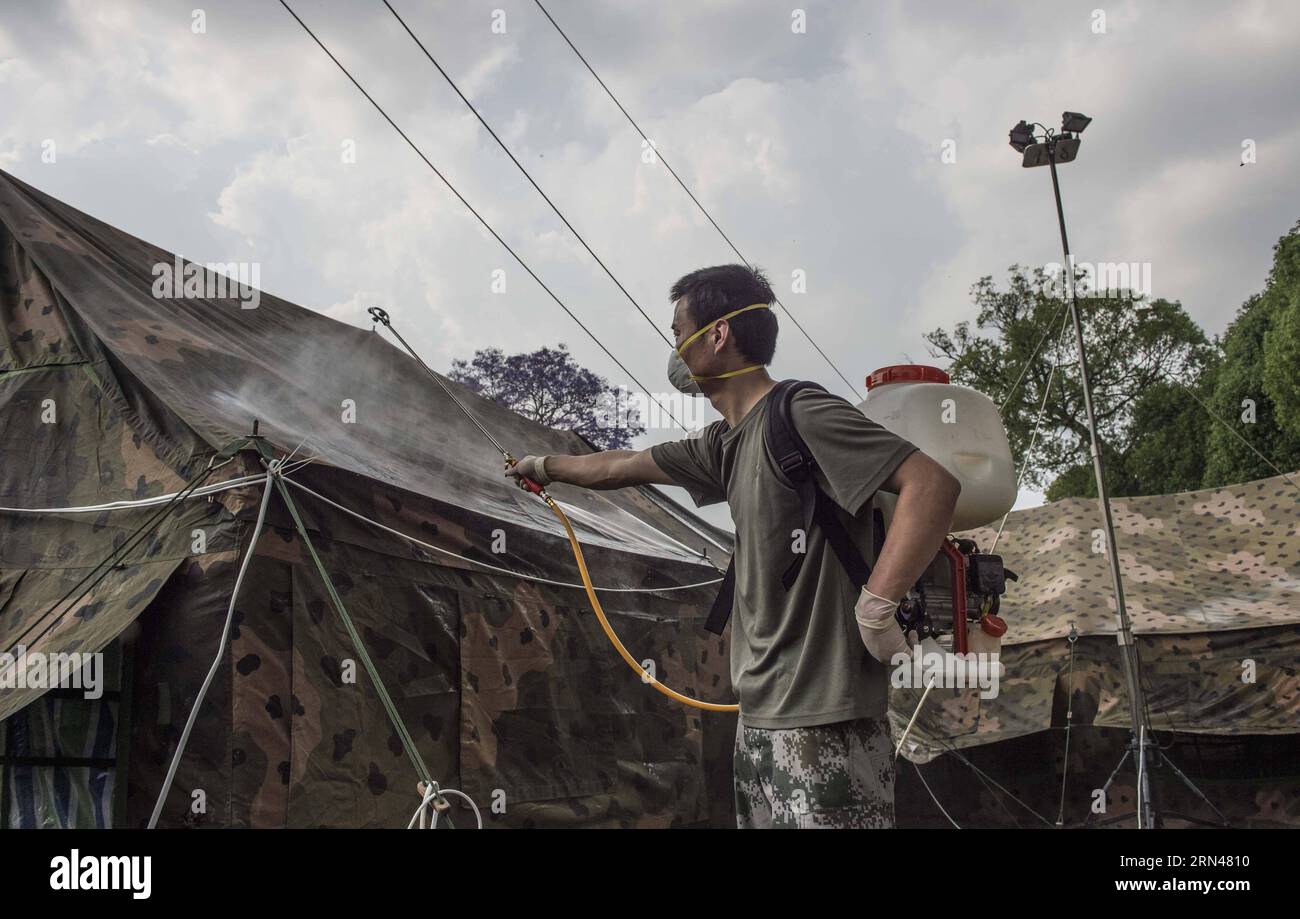 A member of China s Chengdu Military Region Medical Team disinfects the ward tent in Kathmandu, Nepal, May 10, 2015. Since the arrival, the Chengdu Military Region Medical Team, the only foreign aid team capable of performing full-spectrum bone- related surgical operations, has treated over 200 patients, conducted more than 100 surgical operations, including 34 major ones. The team has also provided psychological counseling to nearly 500 people, and has disinfected a total area of over 850,000 square meters. In contrast to their typical International Nurses Day events back in China, which ofte Stock Photo