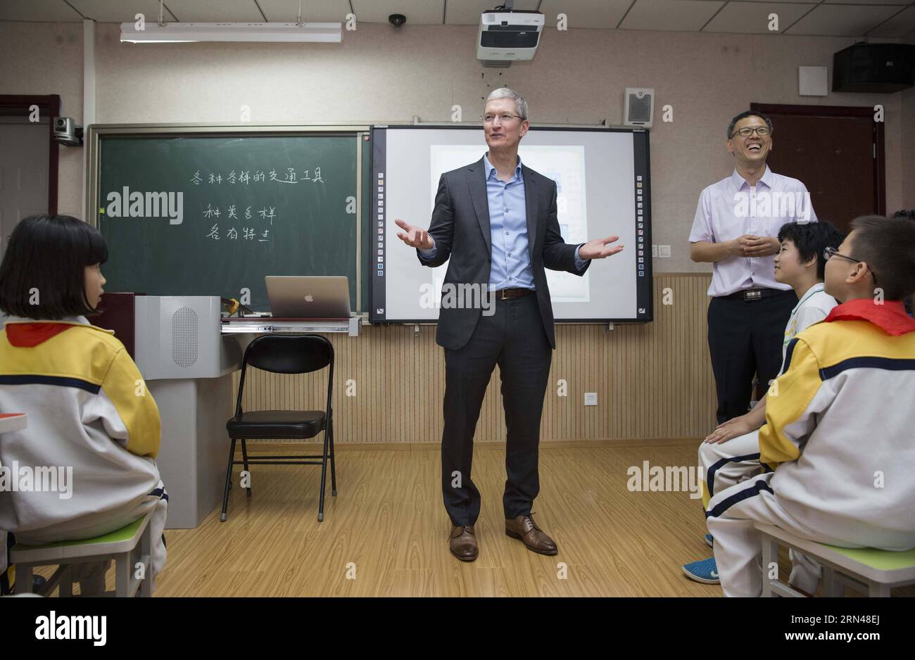 (150512) -- BEIJING, May 12, 2015 -- Tim Cook (C), CEO of Apple Inc., interacts with students during a lesson at the Primary School attached to Communication University of China in Beijing, capital of China, May 12, 2015. Tim Cook visited the Primary School attached to Communication University of China on Tuesday. ) (yxb) CHINA-BEIJING-APPLE CEO-PRIMARY SCHOOL-VISIT(CN) LixMing PUBLICATIONxNOTxINxCHN   150512 Beijing May 12 2015 Tim Cook C CEO of Apple INC interact With Students during a Lesson AT The Primary School Attached to Communication University of China in Beijing Capital of China May Stock Photo