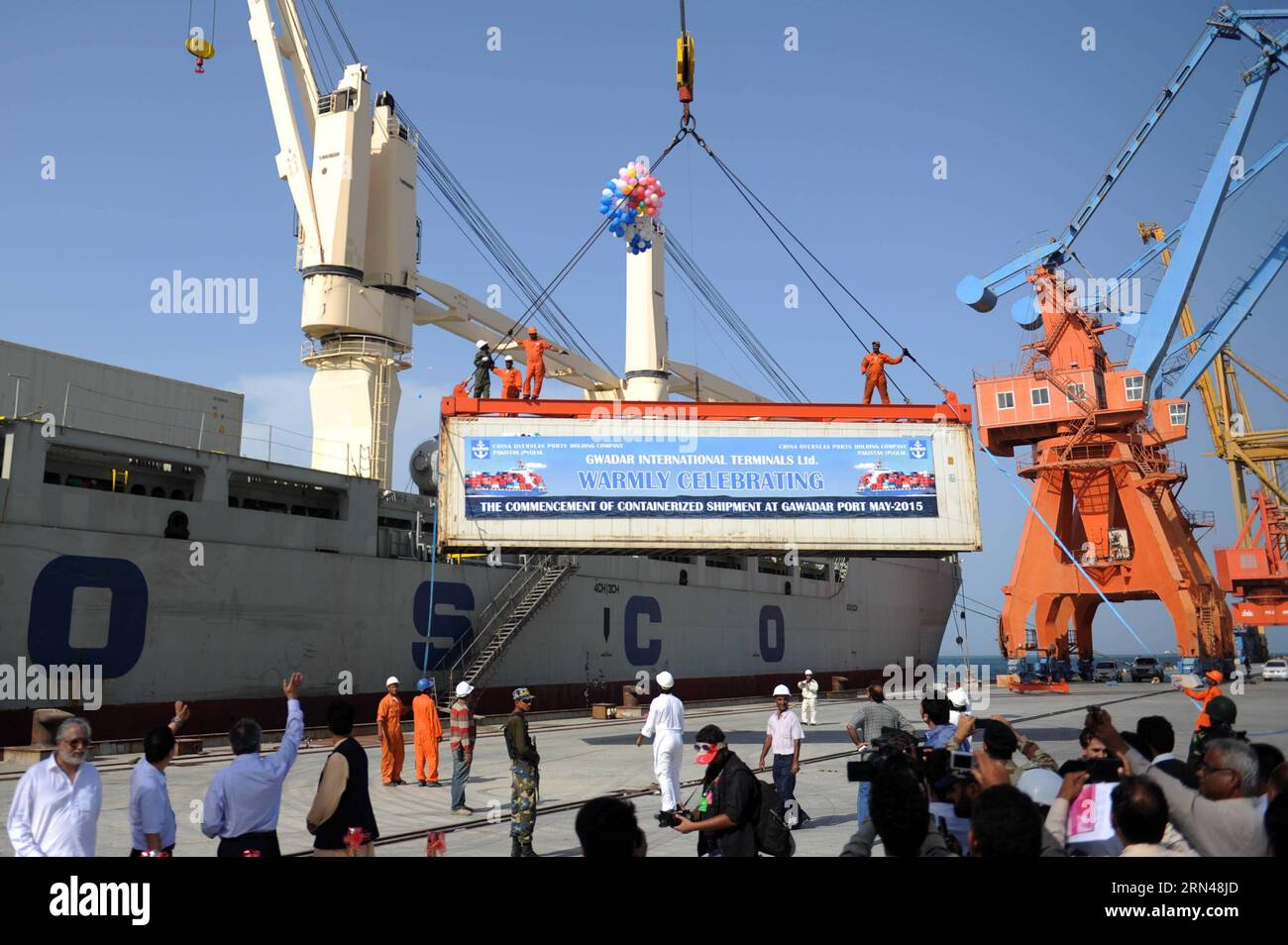 (150512) -- KARACHI,   -- A container is loaded to a ship during the inaugration ceremony of container service at a pier of Gwadar Port, southwestern Pakistan, on May 11, 2015. Gwadar Port, a warm-water, deep-sea port, is located at the mouth of the Persian Gulf in Gwadar of Pakistan s Baloschistan province. China and Pakistan agreed to build China-Pakistan Economic Corridor (CPEC) to connect the Pakistani port with Kashgar city in China s Xinjiang Uygur Autonomous Region. It will shorten China s routes of oil and gas imports from Africa and the Middle East for thousands of kilometers, making Stock Photo