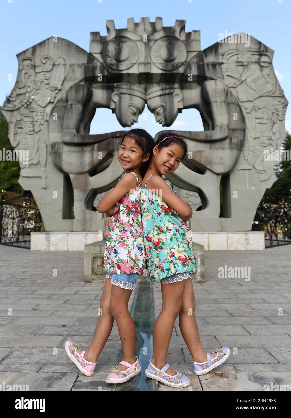 (150514) -- MOJIANG, May 12, 2015 -- Twin sisters Jin Meixian (L) and Jin Huixian play at a park in Mojiang Hani Autonomous County, southwest China s Yunnan Province, May 12, 2015. Twin sisters Jin Meixian and Jin Huixian, 7, live with their mother Wang Fei, who opens a cold drink store. Their father does business in another province. Meixian, the older, loves music and wants to be a musical teacher. Huixian likes dancing, and wants to go to college in Beijing. We always feel connected. Sometimes we find out that we are singing the same song, even the same lyrics. By coincidence, there are ten Stock Photo