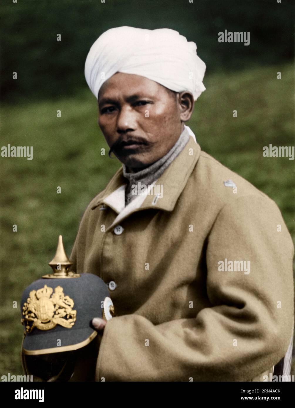 Indian officer wounded, at one of the military hospitals for Indian soldiers at Brighton, with German officer's helmet which he captured at Neuve Chap Stock Photo
