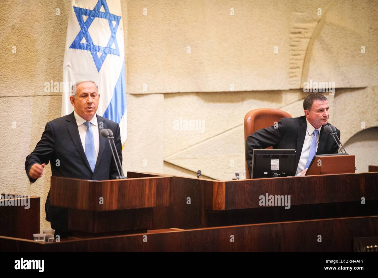 (150514) -- JERUSALEM, May 14, 2015 -- Israeli Prime Minister Benjamin Netanyahu (L) makes a speech before presenting the newly formed government in the Israeli Knesset (parliament) in Jerusalem, on May 14, 2015. The Israeli parliament approved late Thursday night a right-wing government formed by incumbent Prime Minister Benjamin Netanyahu after his Likud party won an early election nearly two months ago. The 20-member cabinet, whose lineup was finalized not long before the vote, is to be sworn in soon after it won the parliament s confirmation in a vote of 61 to 59. ) MIDEAST-JERUSALEM-ISRAE Stock Photo