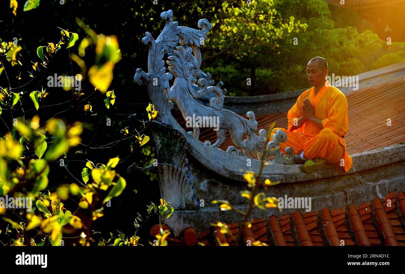 (150517) -- QUANZHOU, May 17, 2015 -- A monk meditates on a rooftop at the Quanzhou Shaolin Temple in Quanzhou City, southeast China s Fujian Province, May 13, 2015. Located in the east of the Qingyuan Mountain of Quanzhou, the Quanzhou Shaolin Temple, also called the South Shaolin Temple, is the birthplace of the South Shaolin martial art, which has spread to Taiwan, Hong Kong and Macao and even Southeast Asia since Ming (1368-1644) and Qing (1644-1911) dynasties. It s also jointly called the South and North Shaolin with Songshan Shaolin Temple in central China s Henan Province. Zen, the doct Stock Photo