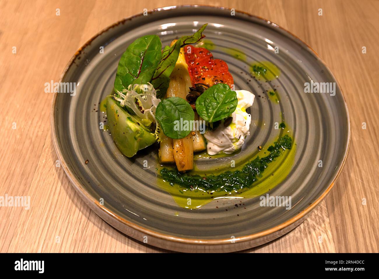 Starter plate with asparagus, salad, burrata, tomatoes and herb pesto, Baden-Wuerttemberg, Germany Stock Photo