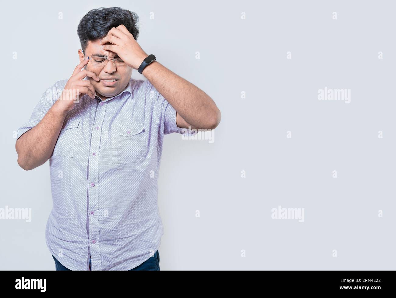 Exhausted person putting the palm of his hand on his face. Fatigued and exhausted man isolated. Concept of a bored and tired man Stock Photo