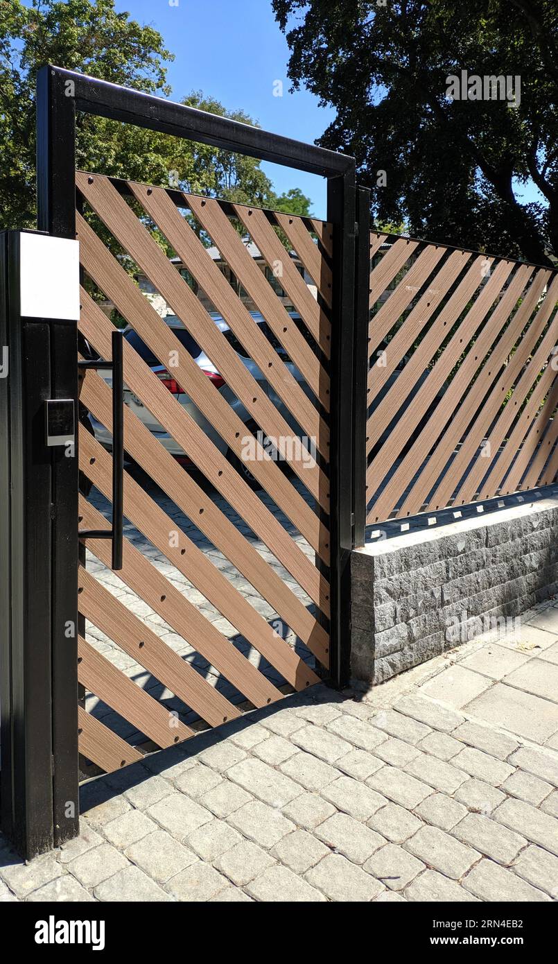 Metal automatic gates of the entrance area. Plastic doors with lifting