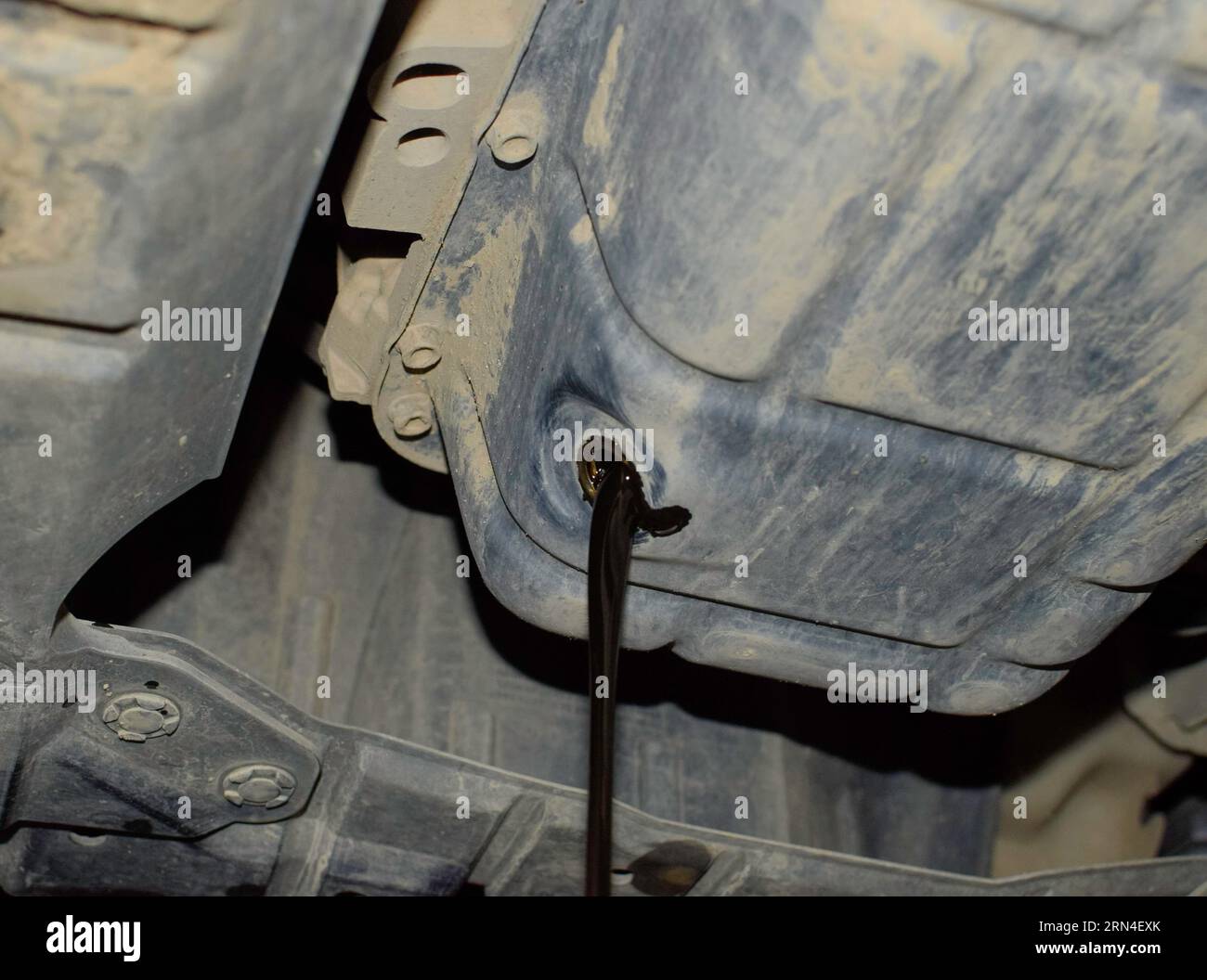 Drain the old oil from the engine through the drain plug. Changing the