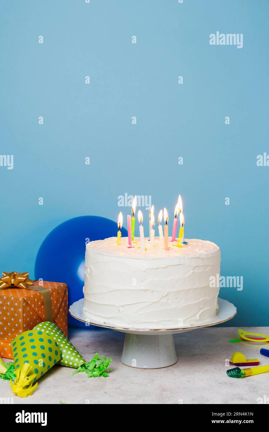 Lit candles birthday cake Stock Photo - Alamy
