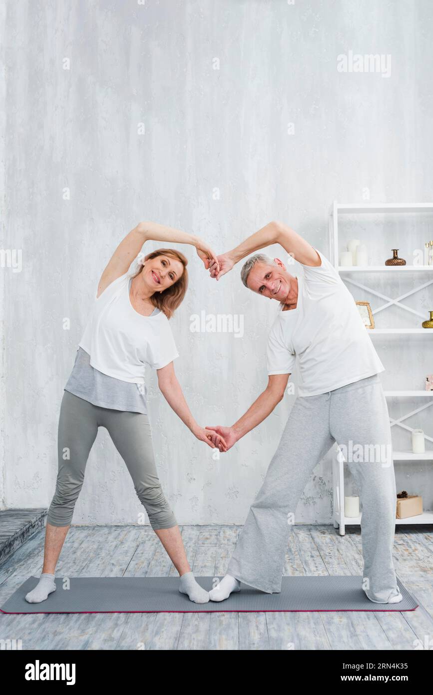 Youve Taught Me The True Meaning Of Love. A Couple Forming A Heart Shape  With Their Hands While Sitting On The Beach. Stock Photo, Picture and  Royalty Free Image. Image 198911221.