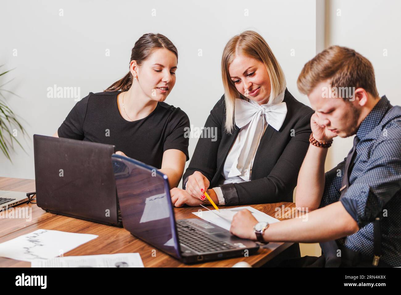 People sitting desk talking Stock Photo