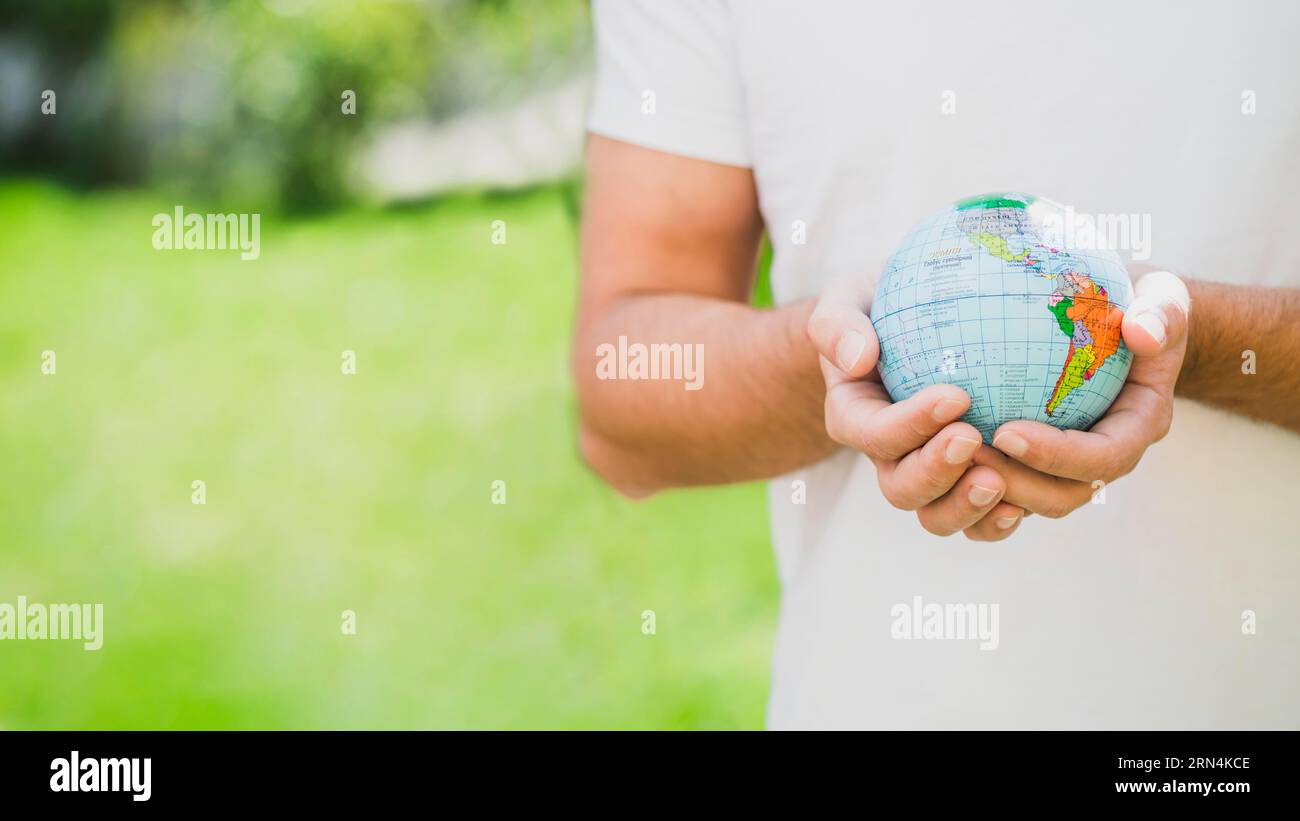 Mid section man holding globe hand Stock Photo