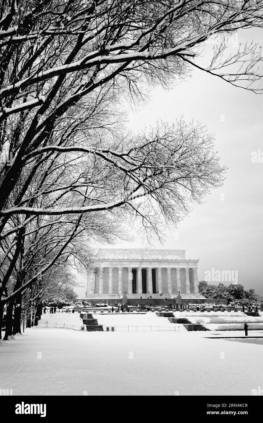 WASHINGTON, DC - The Lincoln Memorial sits on the western end of Washington DC's National Mall. It faces directly east towards the Washington Monument and US Capitol Building. Styled in the form of a neoclassical temple, its main chamber is dominated by a large statue of a seated President Abraham Lincoln. It was designed by Daniel Chester French and completed in 1920. The Lincoln Memorial was dedicated in May 1922. Stock Photo