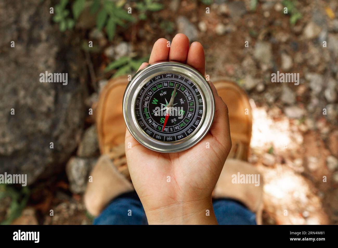 Top view female using compass directions Stock Photo Alamy