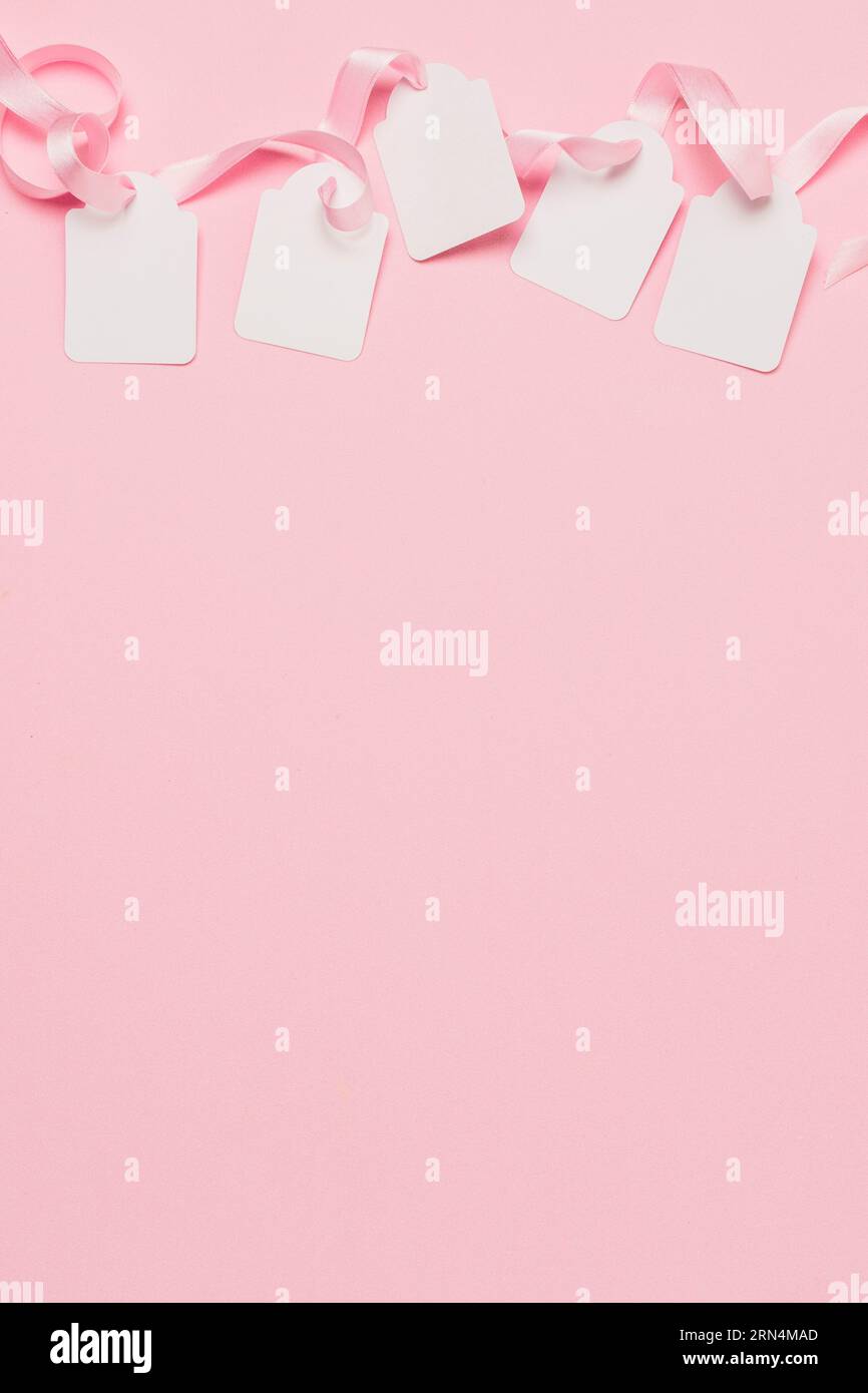 White tags pink ribbon top background with space text Stock Photo Alamy
