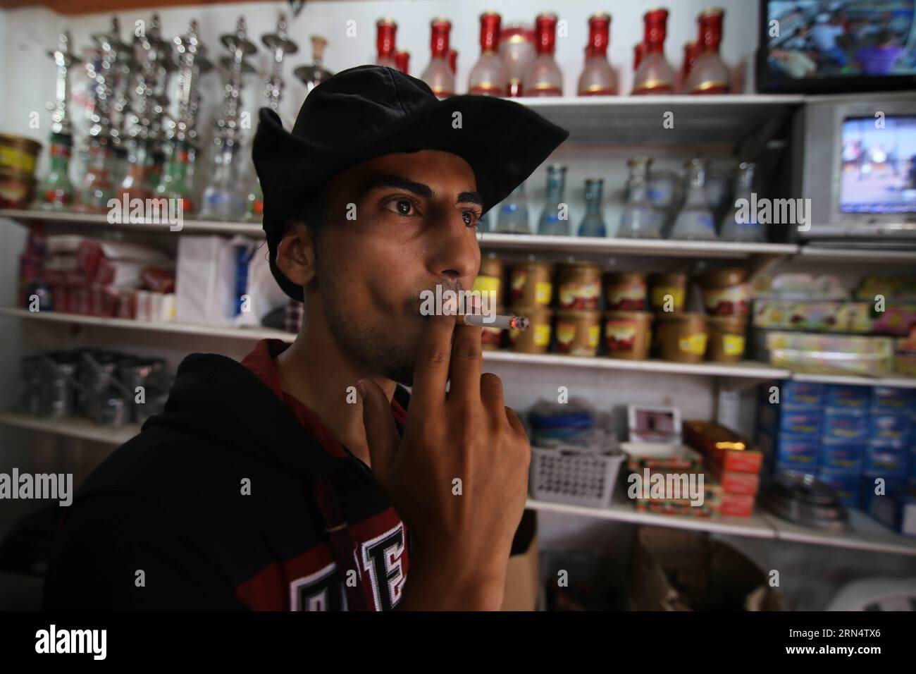 gaza cigarettes 150531) -- GAZA, May 31, 2015 -- A Palestinian vendor smokes cigarettes in  the southern Gaza Strip City of Rafah, on May 23, 2015. Smuggling through  tunnels began several months after Islamic