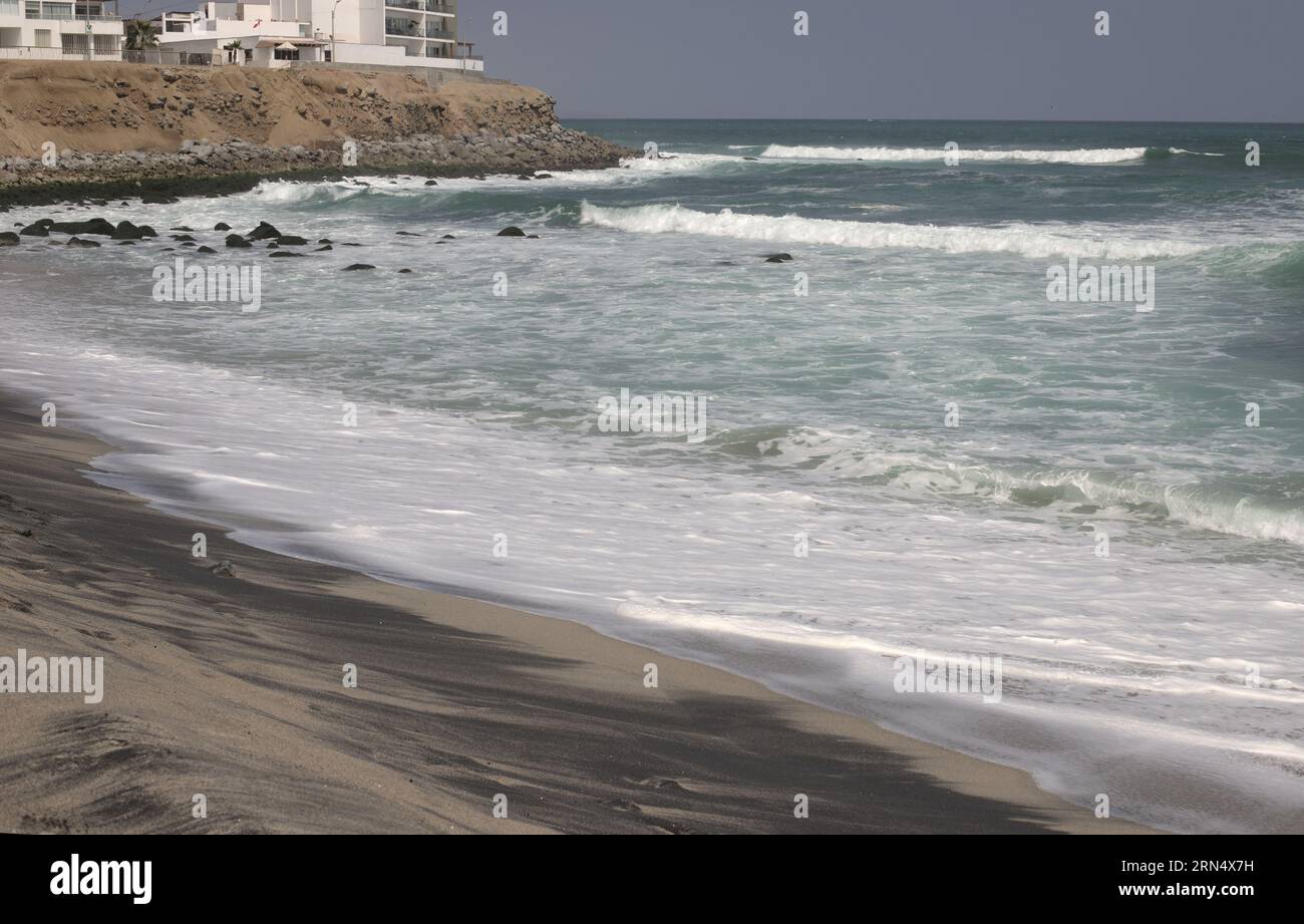 Beach at Punta Hermosa in Lima Peru, pacific ocean water, white waves. Stock Photo