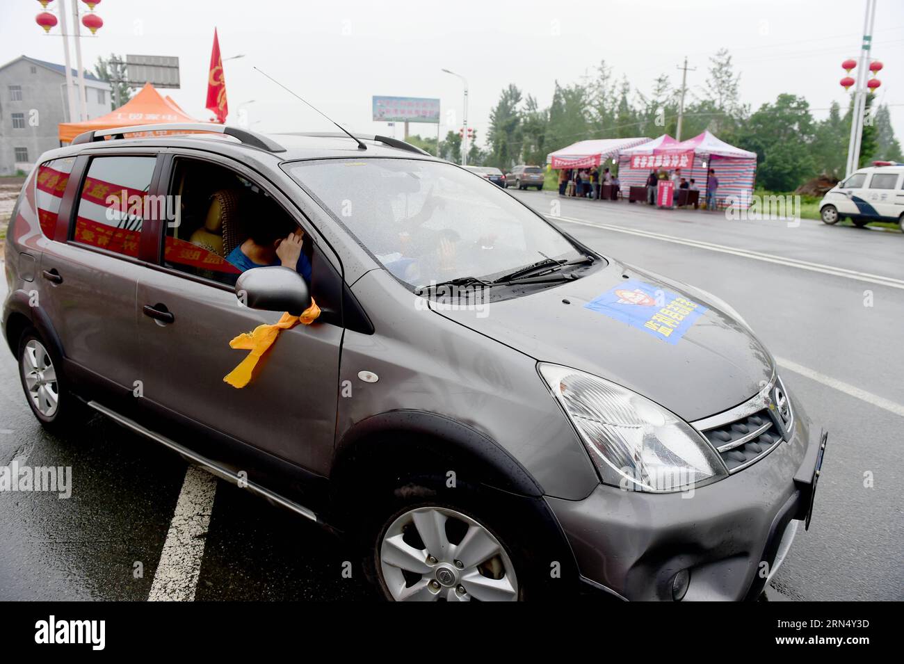 (150604) -- JIANLI, June 4, 2015 -- A car drives on a street with yellow ribbons tied to the rearview mirrors in Jianli, central China s Hubei Province, June 4, 2015. A cruise ship carrying more than 450 people on Monday sank in the Jianli section of the Yangtze River. Many local drivers are joining the rescue effort by offering free rides for rescuers and relatives of victims with the sign of yellow ribbons. ) (wf) CHINA-HUBEI-SHIP SINKING-RESCUE (CN) HaoxTongqian PUBLICATIONxNOTxINxCHN   Jianli June 4 2015 a Car Drives ON a Street With Yellow ribbons Tied to The rearview mirrors in Jianli Ce Stock Photo