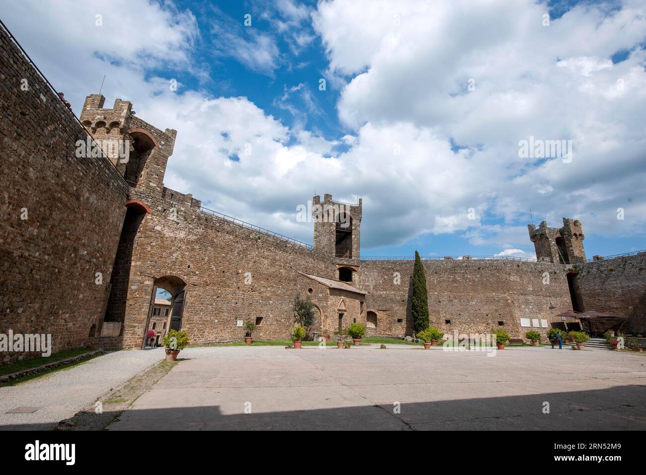 View from courtyard on fortification walls towers watchtowers of castle of Fortezza di Montalcino, left castle gate, Montalcino, Tuscany, Italy Stock Photo
