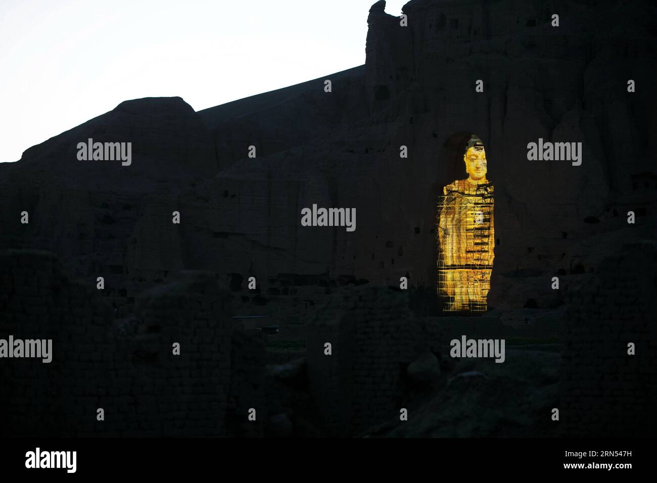 (150612) -- KABUL, June 12, 2015 -- Photo taken on June 7, 2015 shows the projection of the Bamyan Buddha in Bamyan province, central Afghanistan. A Chinese couple, and Liang Hong, successfully projected the image of the tallest Buddha in Bamyan Valley on June 6 and 7, using the latest cultural relics-friendly technology, eliciting cheers from the local people. The two Bamyan Buddhas were bombed and smashed to the ground by Taliban in 2001 despite appeals from the international community. ) AFGHANISTAN-BAMYAN-BAMYAN BUDDHA-IMAGE PROJECTION ZhangxXinyu PUBLICATIONxNOTxINxCHN   150612 Kabul June Stock Photo