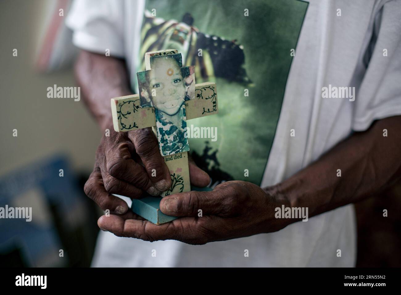 NEW ORLEANS, June 12, 2015 -- Robert Green, a Lower Ninth Ward resident and Hurricane Katrina survivor, shows a faded photo of her grand daughter, who was killed in the hurricane at the age of 3, in Lower Ninth Ward, New Orleans, Louisiana, June 12, 2015. Ten years after Hurricane Katrina brought New Orleans to its knees and left an emotional footprint across the United States as people witnessed how the U.S. government failed to respond promptly, a predominantly African-American community of the city still struggles to define what their post-Katrina life would be. ) (lrz) US-NEW ORLEANS-HURRI Stock Photo