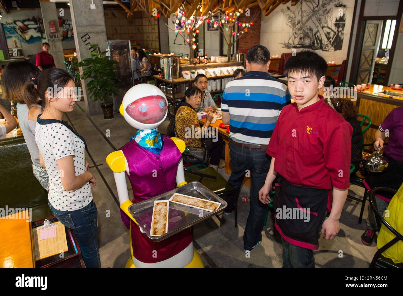 150615-chongqing-june-15-2015-a-robot-serves-dishes-at-a