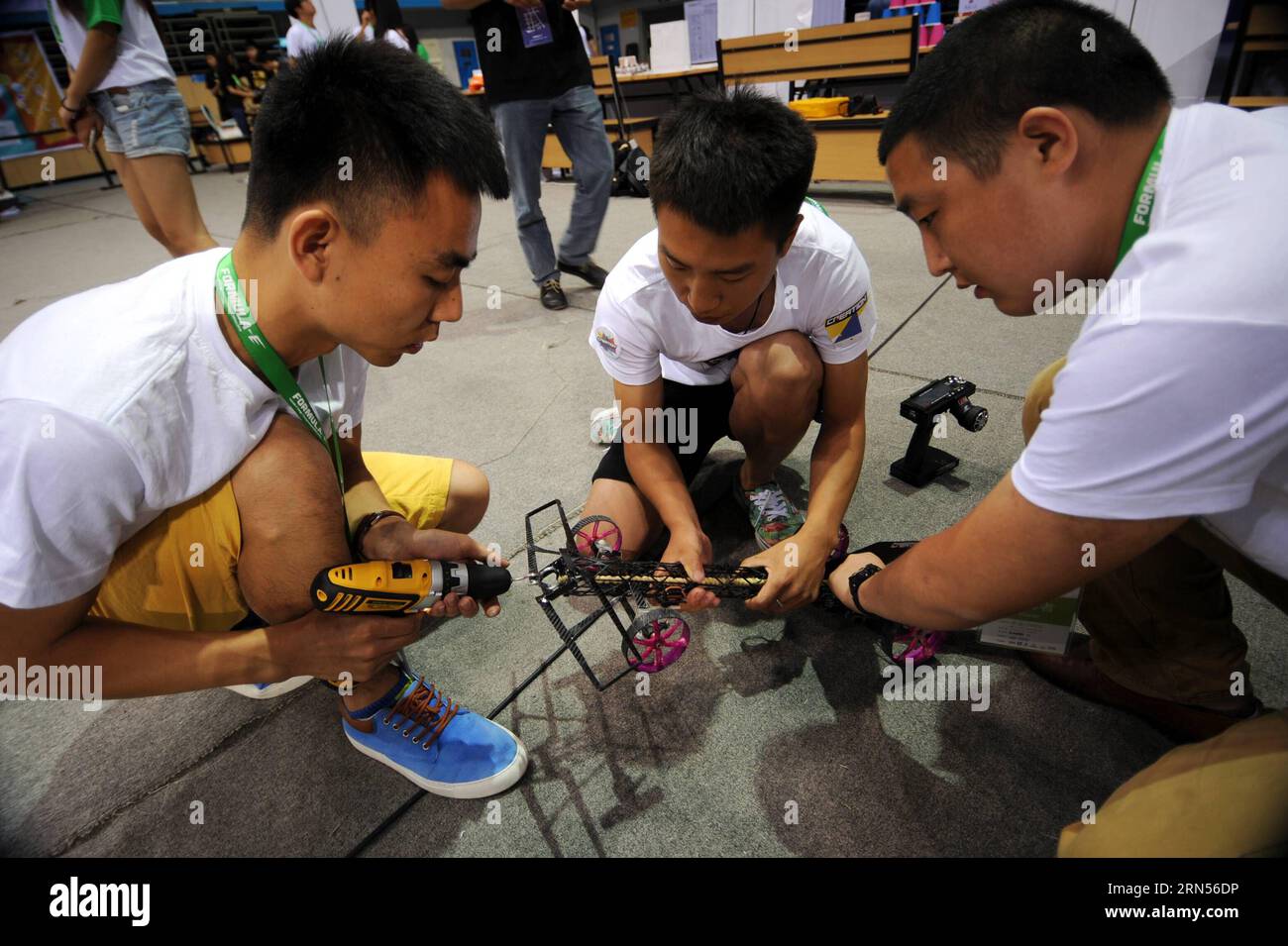 (150615) -- BEIJING, June 15, 2015 -- Competitors twist rubber band to supply power for their elastic model car during the competition in Beijing, capital of China, June 15, 2015. The 2015 Formula-E China Design Championship was held at Beijing University of Technology on Monday. Thirty-five teams from fourteen universities in China competed for the opportunity to attend the global final held in Los Angeles in August. ) (zkr) CHINA-BEIJING-FORMULA-E DESIGN CHAMPIONSHIP(CN) LiuxYongzhen PUBLICATIONxNOTxINxCHN   Beijing June 15 2015 Competitors Twist Rubber Tie to Supply Power for their Elastic Stock Photo