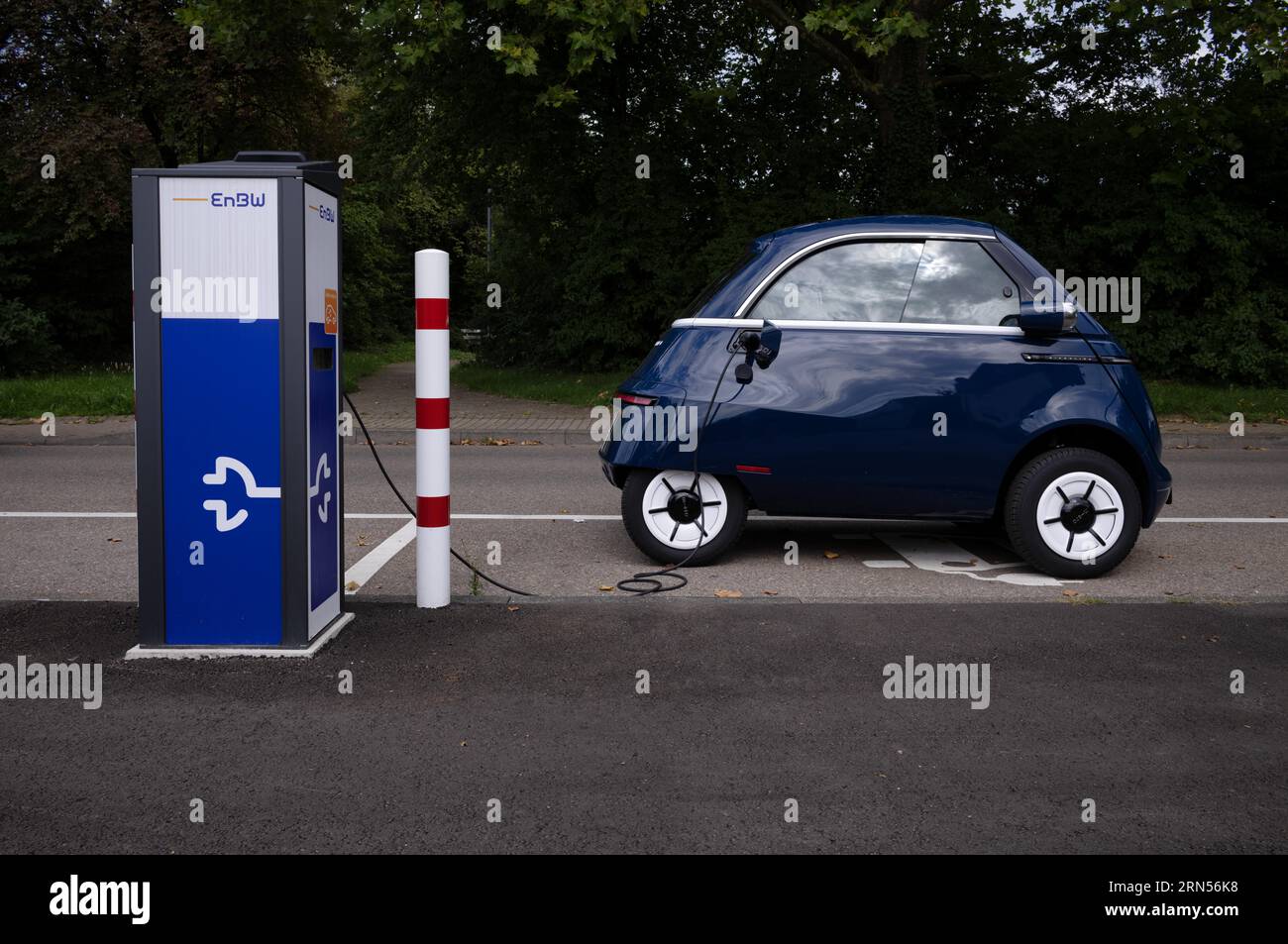E-light vehicle, cabin scooter MICROLINO at charging station EnBW for electric cars, electric charging station, e-filling station, e-mobility Stock Photo
