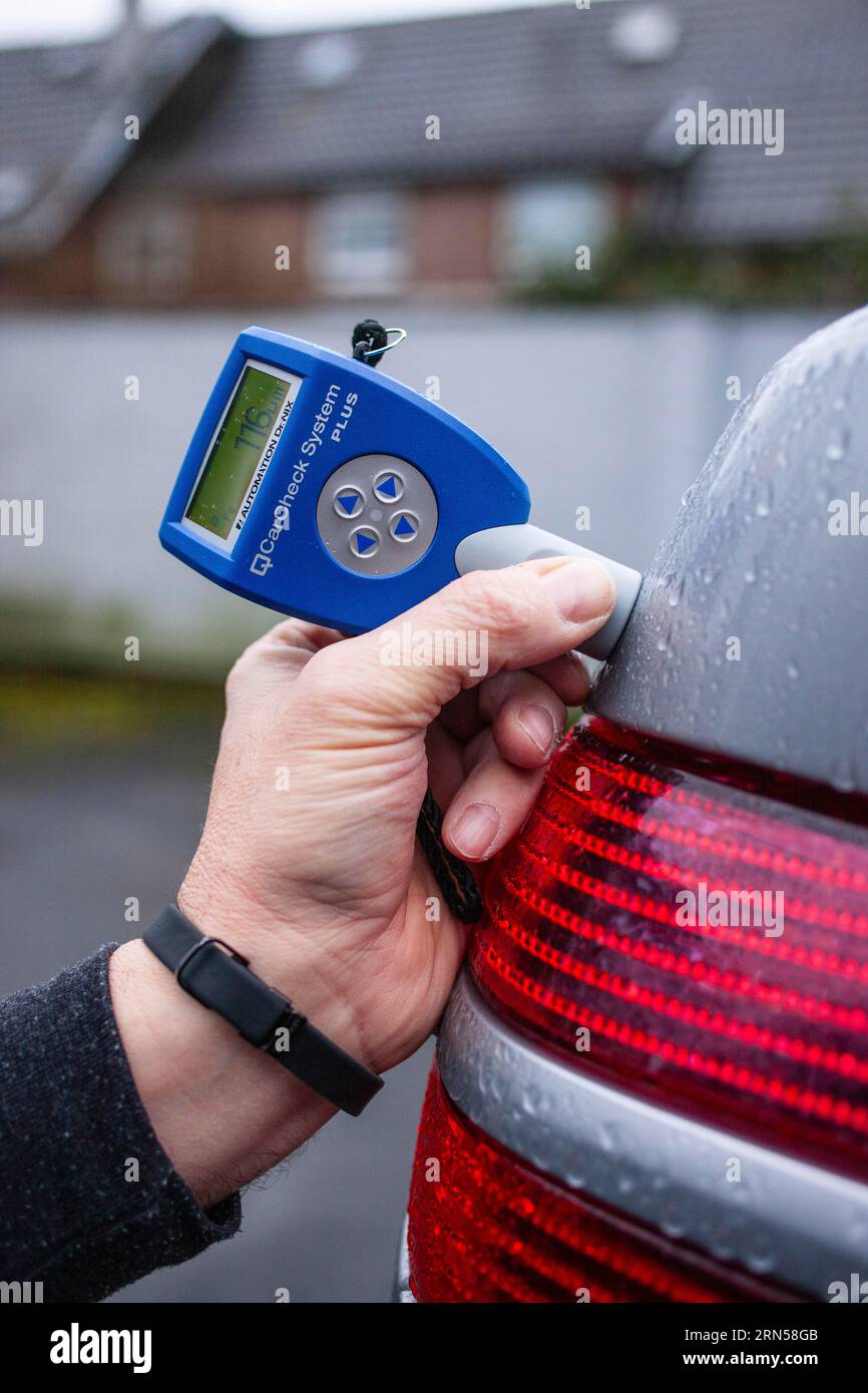 Testing the thickness of paint on a car Stock Photo Alamy