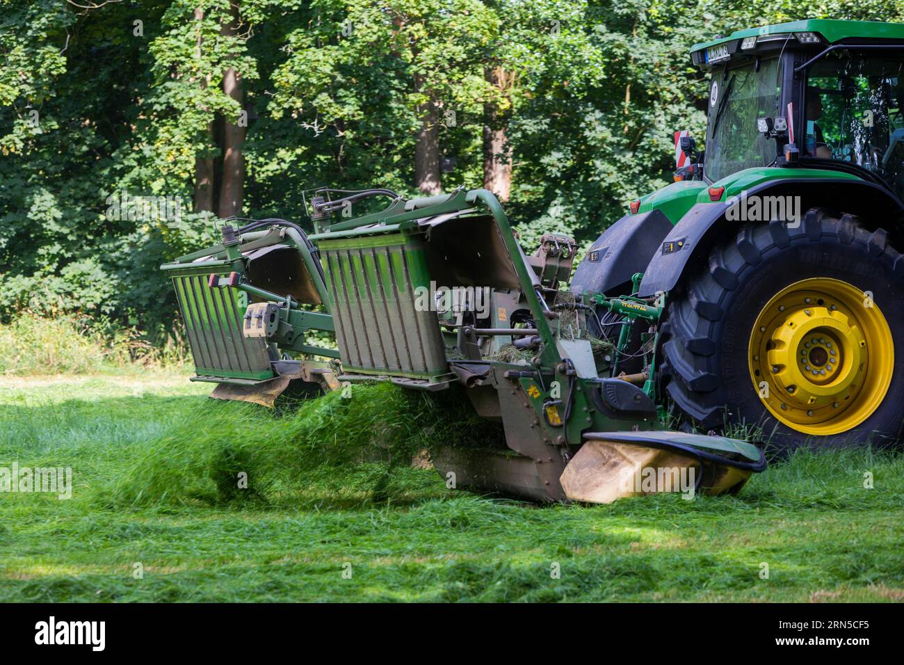 Grass mowing in a small field near Waldheim with a John Deere tractor