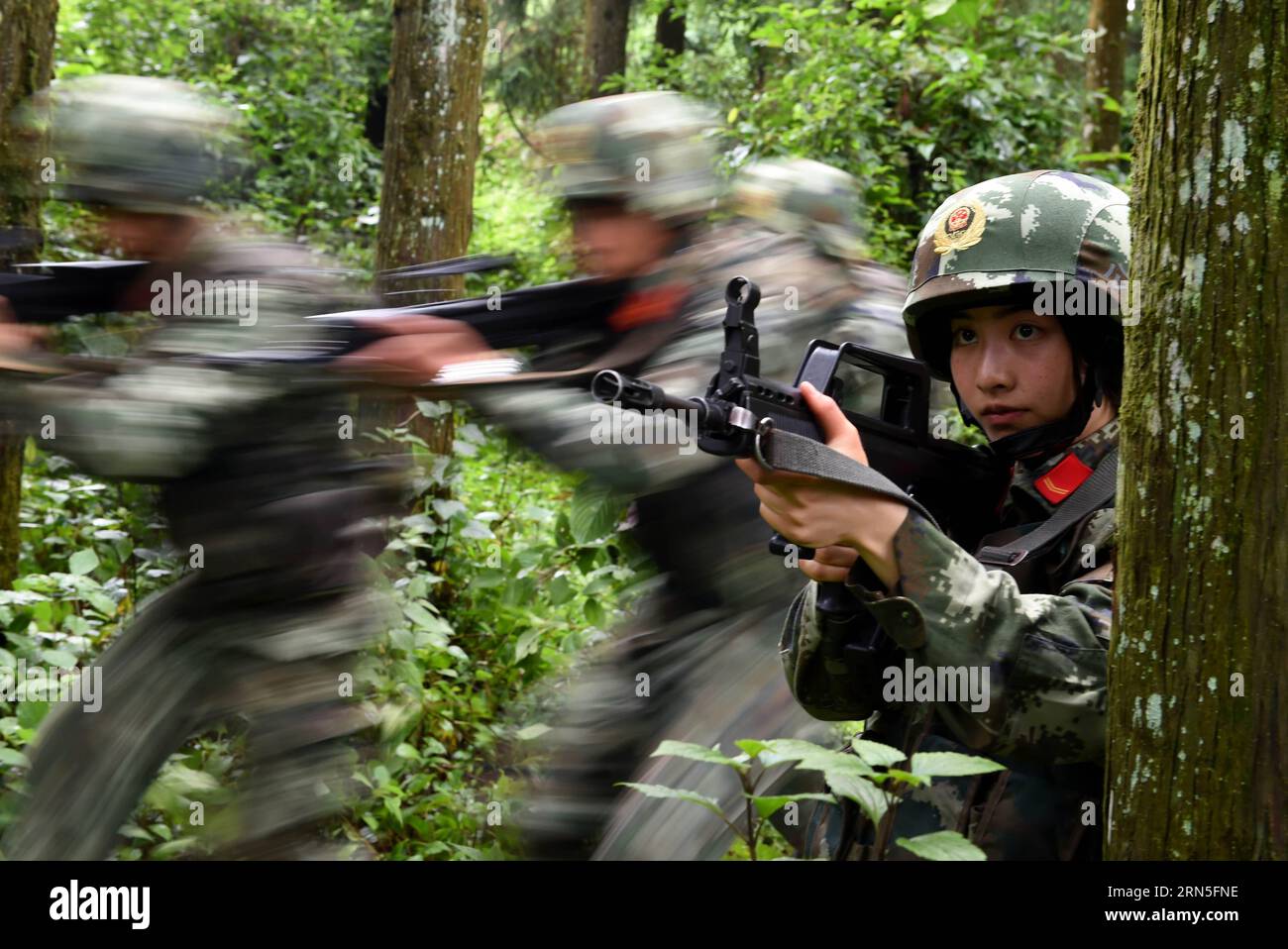 DEHONG, June 24, 2015 -- Zhang Liu takes part in a drilling in the jungle at the border area near Myanmar in Dehong Dai-Jingpo Autonomous Prefecture, southwest China s Yunnan Province, June 24, 2015. Born in 1995, Zhang Liu became an anti-drug soldier in border checkpoint of Mukang in 2013. Grown up in an affluent family in central China s Hunan Province, Zhang said that being a soldier had always been her dream, which drove her to join the army after graduating from high school. Being a front line anti-drug force, the border checkpoint of Mukang has captured about 100 kilograms of drugs since Stock Photo