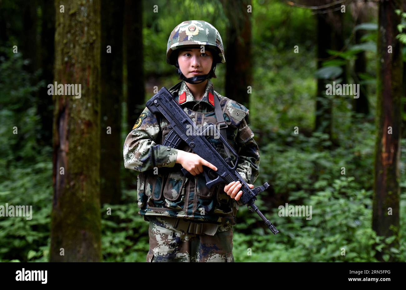 DEHONG, June 24, 2015 -- Zhang Liu takes part in a drilling in the jungle at the border area near Myanmar in Dehong Dai-Jingpo Autonomous Prefecture, southwest China s Yunnan Province, June 24, 2015. Born in 1995, Zhang Liu became an anti-drug soldier in border checkpoint of Mukang in 2013. Grown up in an affluent family in central China s Hunan Province, Zhang said that being a soldier had always been her dream, which drove her to join the army after graduating from high school. Being a front line anti-drug force, the border checkpoint of Mukang has captured about 100 kilograms of drugs since Stock Photo