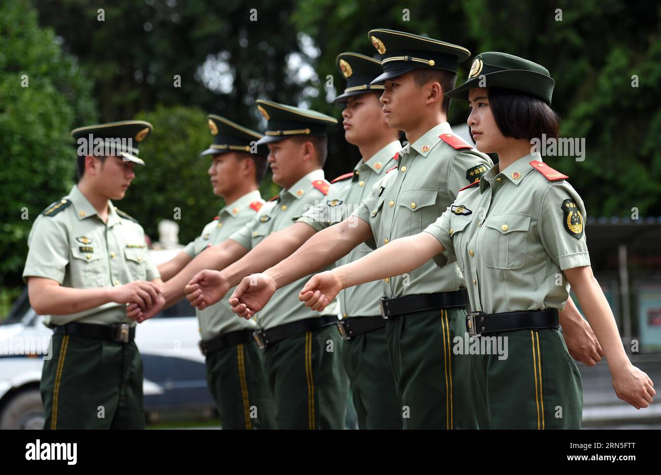 DEHONG, June 24, 2015 -- Zhang Liu (1st R) and her comrades are trained at the border checkpoint of Mukang in Dehong Dai-Jingpo Autonomous Prefecture, southwest China s Yunnan Province, June 24, 2015. Born in 1995, Zhang Liu became an anti-drug soldier in border checkpoint of Mukang in 2013. Grown up in an affluent family in central China s Hunan Province, Zhang said that being a soldier had always been her dream, which drove her to join the army after graduating from high school. Being a front line anti-drug force, the border checkpoint of Mukang has captured about 100 kilograms of drugs sinc Stock Photo