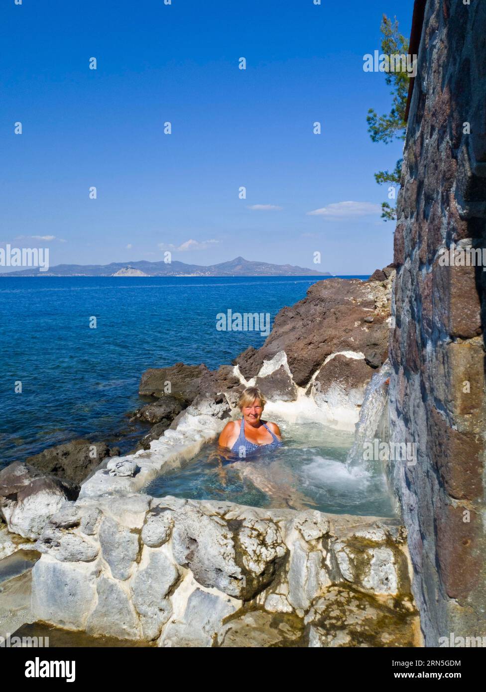 Woman in mini-pool, thermal bath with hydrogen sulphide gases ...