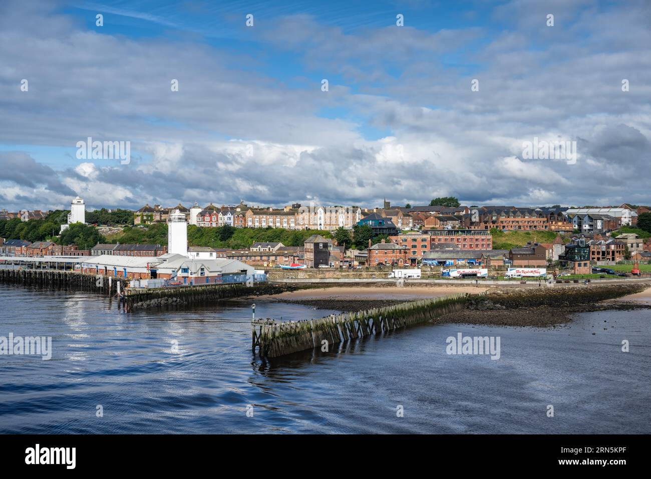 North bank of the River Tyne, fish market on the left with the Old Low lighthouse on the right and the Fish Quay High lighthouse on the left, North Stock Photo