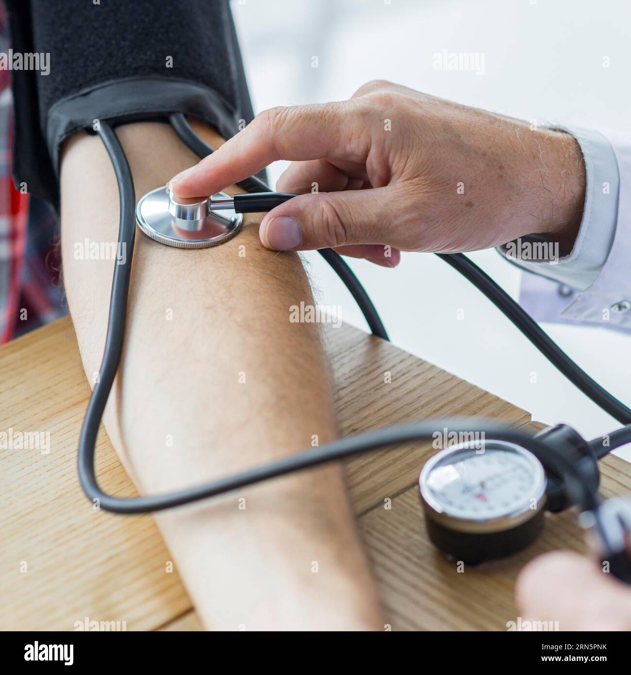 Crop hand with stethoscope measuring blood pressure Stock Photo Alamy